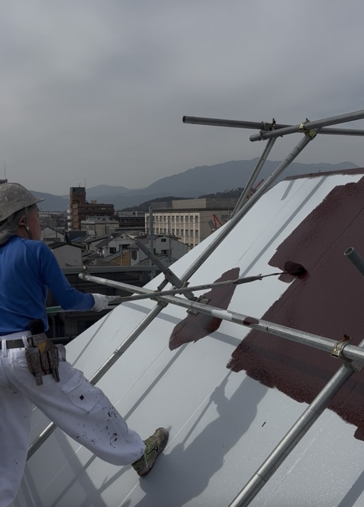 伏見区正木建装が、破風屋根にシリコン塗料中塗り作業1